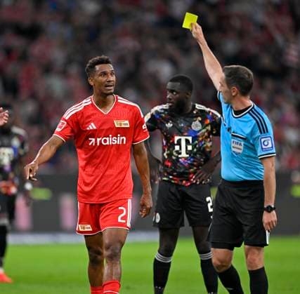 September 18, 2026, 2026–2027 Bundesliga, Matchday 4, FC Bayern Munich vs. 1. FC Union Berlin, at the Allianz Arena in Munich, Felix Uduokhai of Union Berlin receives a yellow card