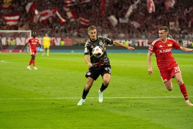 September 18, 2026: Soccer—FC Bayern Munich vs. Union Berlin, Matchday 4 of the Bundesliga at the Allianz Arena in Munich. Josip Stanisic (FC Bayern Munich), No. 44, vs. Michel Aebischer (Union Berlin), 20 IMPORTANT NOTICE: In accordance with DFL and DFB regulations, it is prohibited to use or allow the use of photographs taken in the stadium and or during the game in the form of sequential images and or video-like photo sequences. Copyright: xJamesxZabelx