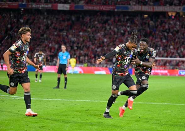 September 18, 2026, 2026–2027 Bundesliga Season, Matchday 4, FC Bayern Munich vs. 1. FC Union Berlin, at the Allianz Arena in Munich; from left: Tom Bischof (FC Bayern Munich), Michael Olise (FC Bayern Munich), and Alphonso Davies (FC Bayern Munich) celebrate