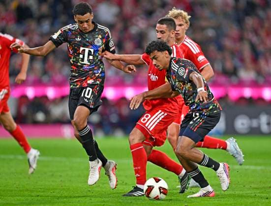September 18, 2026, 2026–2027 Bundesliga Season, Matchday 4, FC Bayern Munich vs. 1. FC Union Berlin, at the Allianz Arena in Munich, from left: Jamal Musiala (Bayern Munich), Rani Khedira (Union Berlin), and Nathaniel Brown (FC Bayern Munich)