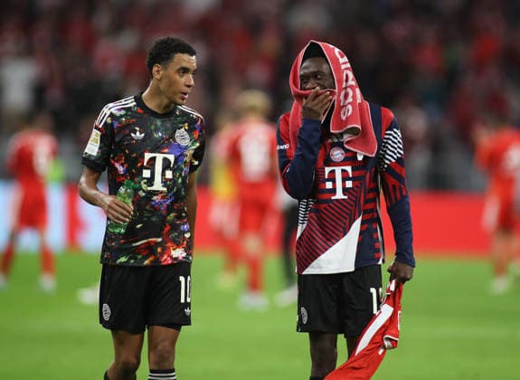 Soccer, Men s, Bundesliga, 2026–2027 Season, FC Bayern Munich vs. 1. FC Union Berlin, Allianz Arena: Jamal Musiala (FC Bayern Munich, left) and Alphonso Davies (FC Bayern Munich, right) talking after the game. DFB and DFL regulations prohibit any use of photographs as image sequences and or quasi-video.