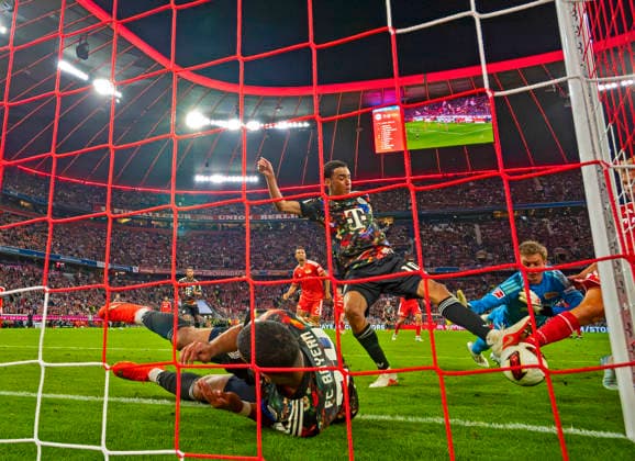 September 18, 2026, 2026–2027 Bundesliga Season, Matchday 4, FC Bayern Munich vs. FC Union Berlin, at the Allianz Arena in Munich, battling for a scoring opportunity, from left: Ismael Saibari (FC Bayern Munich), Jamal Musiala (Bayern Munich), goalkeeper Frederik Rönnow (Union Berlin)
