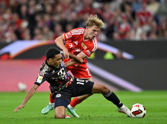 Tackle, Action: Andras Schaefer (1. FC Union Berlin, FCU) 13 vs. Jamal Musiala (FC Bayern Munich, FCB) 10 FC Bayern Munich (FCB) vs. 1. FC Union Berlin (FCU) September 18, 2026 DFL regulations prohibit any use of photographs as IMAGE SEQUENCES AND OR QUASI-VIDEO. FC Bayern Munich (FCB) vs. 1. FC Union Berlin (FCU)