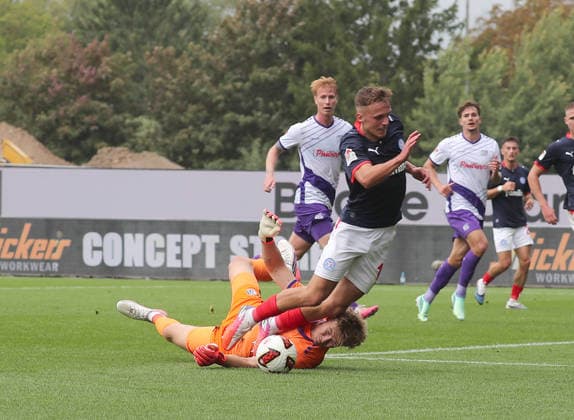 Jonas Krumrey of VfL Osnabrück fouls Phil Harres of Holstein Kiel; penalty kick; soccer; men s; 2026–2027 season, 2. Bundesliga, Holstein Stadium, Holstein Kiel vs. VfL Osnabrück DFL REGULATIONS PROHIBIT ANY USE OF PHOTOGRAPHS AS IMAGE SEQUENCES AND OR QUASI-VIDEO