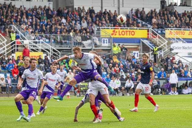 September 19, 2026, Men s Soccer, 2. Bundesliga, 2026–2027 Season, Matchday 6: Holstein Kiel vs. VFL Osnabrück; Kiel in white and blue, Osnabrück in sky blue; Fridolin Wagner (left), Phil Harres; Kiel Holstein Stadium, Westring 501, Schleswig-Holstein, Germany