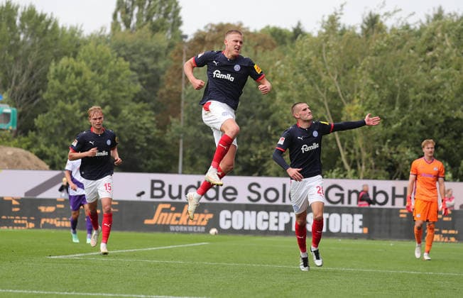 Phil Harre s Holstein Kiel converts the penalty kick to make it 1–0; Phil Harre s Holstein Kiel celebrates; on the left, Kasper Davidsen of Holstein Kiel; on the right, David Zec of Holstein Kiel; Soccer, Men s, 2026–2027 Season, 2. Bundesliga, Holstein Stadium, Holstein Kiel vs. VfL Osnabrück. DFL regulations prohibit any use of photographs as image sequences and or quasi-video.