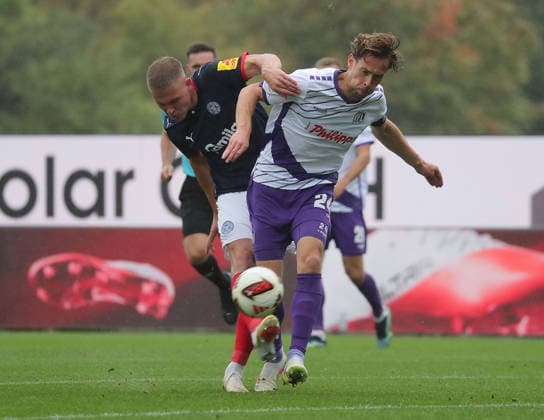 Phil Harres, Holstein Kiel; Jannik Mueller, VfL Osnabrück; Soccer, Men s, 2026–2027 Season, 2. Bundesliga, Holstein Stadium, Holstein Kiel vs. VfL Osnabrück. DFL regulations prohibit any use of photographs as image sequences and or quasi-video.