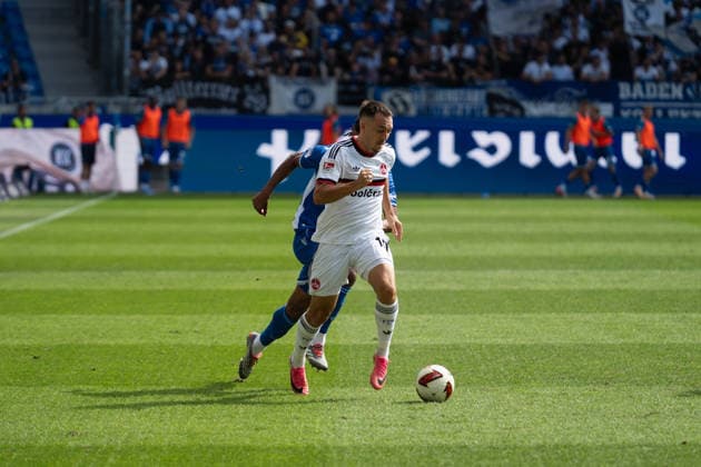 September 19, 2026, xjyhynx, Soccer 2. Bundesliga, Karlsruher SC vs. 1. FC Nürnberg, from left: Julian Justvan dribbling at 10, 1 FC Nürnberg DFL DFB REGULATIONS PROHIBIT ANY USE OF PHOTOGRAPHS AS IMAGE SEQUENCES AND OR QUASI-VIDEO Karlsruhe
