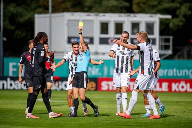 September 19, 2026, xsefx, Soccer, FC Viktoria Köln vs. FC Ingolstadt 04, 3rd Division, Sportpark Höhenberg, Matchday 7, 2026–2027 Season. Referee Fabienne Michel shows a yellow card to Yannick Tonye of FC Viktoria Köln 07. DFB regulations prohibit any use of photographs as image sequences and or quasi-video. North Rhine-Westphalia, Germany