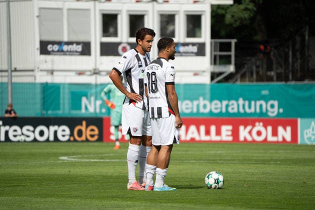 German Soccer, 3rd Division, 2026–27, Matchday 7, September 19, 2026: FC Viktoria Köln vs. FC Ingolstadt 04 at Sportpark Höhenberg in Cologne. Keanan Bennett (FC Ingolstadt 04, No. 18) and Fredrik Carlsen (FC Ingolstadt 04, No. 8) line up for a free kick in Cologne, Germany. Copyright: xMijoxLubecx