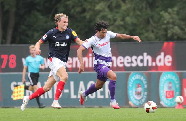 Noah Madsen, Holstein Kiel; Jonathan Gomez, VfL Osnabrück; Soccer, Men s, 2026–2027 Season, 2. Bundesliga, Holstein Stadium, Holstein Kiel vs. VfL Osnabrück, 1–1. DFL regulations prohibit any use of photographs as image sequences and or quasi-video.