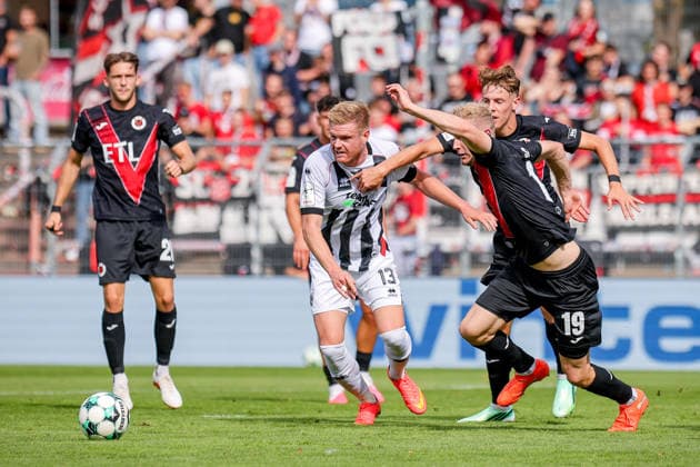September 19, 2026, xsefx, Soccer, FC Viktoria Köln vs. FC Ingolstadt 04, 3. Liga, Sportpark Höhenberg, Matchday 7, 2026–2027 Season: Lars Lokotsch (FC Ingolstadt 04) 13 in a tackle against Meiko Sponsel (FC Viktoria Köln) 19. DFB regulations prohibit any use of photographs as image sequences and or quasi-video. North Rhine-Westphalia, Germany