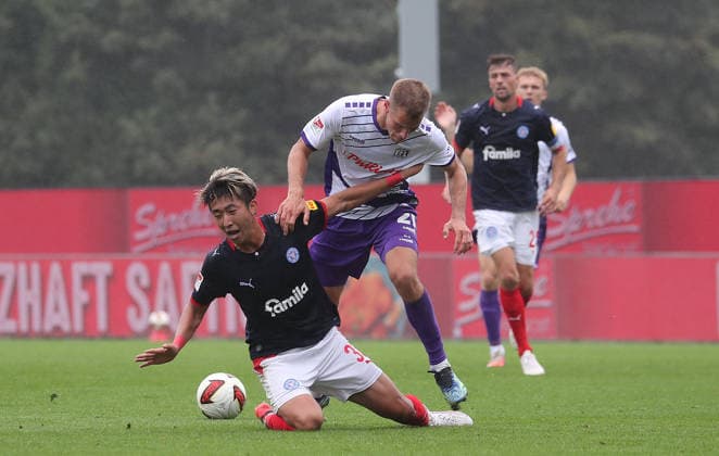 Match between Hiroki Sekine (Holstein Kiel) and Adrian Beck (VfL Osnabrück) — Men s Soccer, 2026–2027 Season, 2nd Bundesliga, Holstein Stadium, Holstein Kiel vs. VfL Osnabrück, 1–1. DFL regulations prohibit any use of photographs as image sequences and or quasi-video.