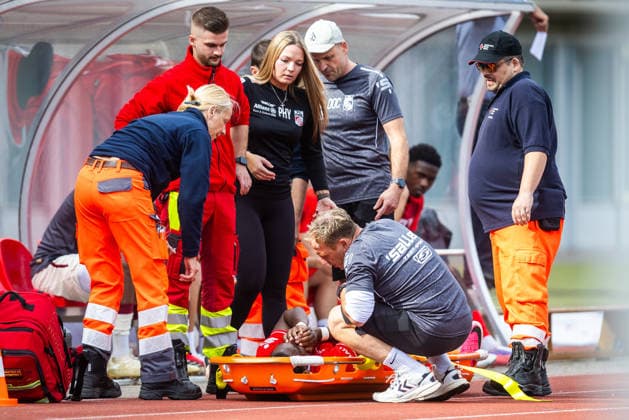 Erfurt, June 26, 1909, Soccer: Northeast Regional League—FC Rot-Weiß Erfurt vs. Erzgebirge Aue. Pictured: Maxime Awoudja of Erfurt is carried off the field after being injured.