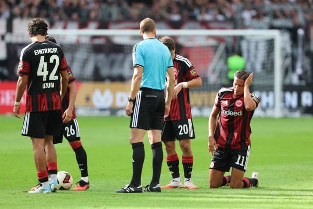 Younes Ebnoutalib of Eintracht Frankfurt, No. 11, grabbing his head after a header duel that ended with him on the ground; Eintracht Frankfurt vs. SC Freiburg, Bundesliga, BL, 2026–2027 season, Match 4, September 19, 2026, Frankfurt, Deutsche Bank Park, Germany