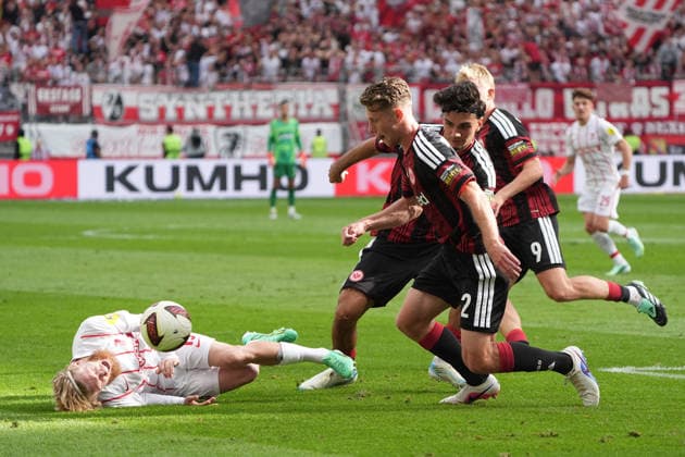 Elias Baum of Eintracht Frankfurt retrieves the ball; Niklas Beste of SC Freiburg is on the ground. September 19, 2026, Bundesliga, Season 26–27: Eintracht Frankfurt vs. SC Freiburg, Deutsche Bank Park, Matchday 4