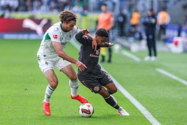 Soccer, Bundesliga 1, Matchday 4: Borussia Mönchengladbach 1, FSV Mainz 05 on September 19, 2026, at Ista Borussia Park in Mönchengladbach. Joe Scally (Mönchengladbach), on the left, Phillipp Mwene of Mainz; on the right, DFL regulations prohibit any use of photographs as image sequences and or quasi-video xJRx