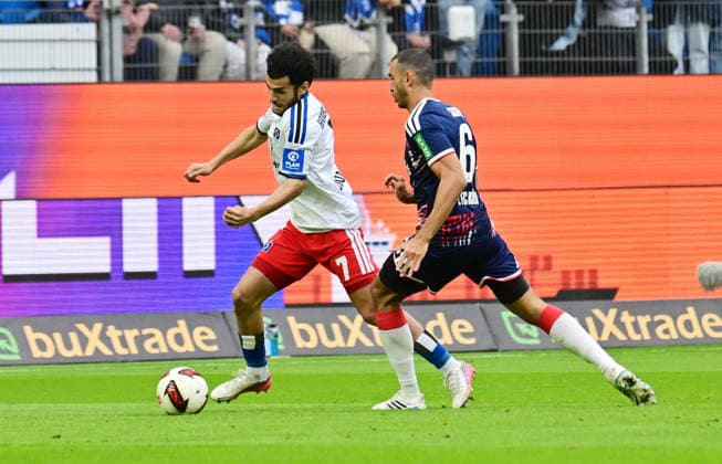 September 19, 2026, German Soccer, Men, 1st Division, Matchday 4, 2026–2027 Season, Hamburg, Hamburger SV vs. 1. FC Köln; Zakaria El Ouahdi (HSV 07) tries to get past Ellyes Skhiri (Köln 06); DFB and DFL regulations prohibit any use of photographs as image sequences and or quasi-video; Hamburg Volksparkstadion, Hamburg, Germany Copyright: xnordphotoxGmbH xWitkex