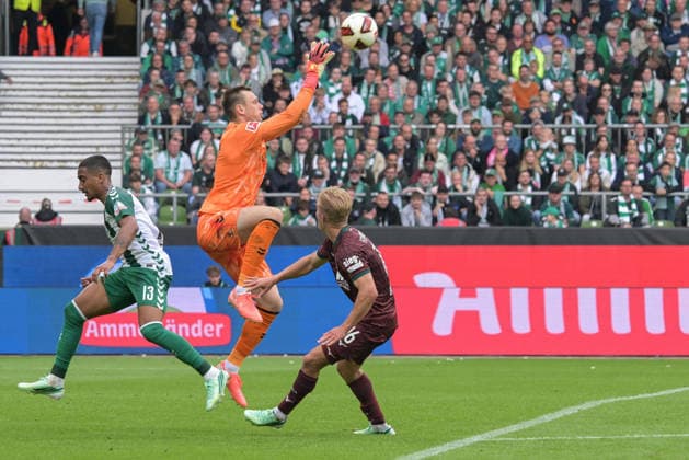 Goalkeeper Karl Hein of SV Werder Bremen 1 makes a save against Hennes Behrens of FC Augsburg 16; SV Werder Bremen, FC Augsburg, soccer, Bundesliga, DFL, September 19, 2026. DFB regulations prohibit any use of photographs as image sequences and or quasi-video. Bremen, Bremen, Germany Copyright: xkolbert-press BurghardxSchreyerx