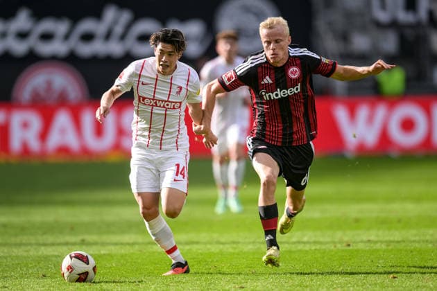 Soccer, Bundesliga 1, 20260919, SG Eintracht Frankfurt vs. SC Freiburg. Pictured, from left: Yuito SUZUKI (Freiburg, 14) and Oscar HOJLUND (Frankfurt, 6) in a tackle for the ball. Frankfurt, Deutsche Bank Park, Hesse, Germany Copyright: Passion2Press MarkusxFischerx