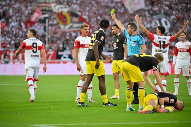 After a tackle, Foul by Ermedin Demirovic (VfB Stuttgart 09) against Waldemar Anton (Borussia Dortmund BVB 03); referee Tobias Stieler shows Ermedin Demirovic (VfB Stuttgart 09) a yellow card; VfB Stuttgart vs. Borussia Dortmund BVB 19 09 2026 DFL regulations prohibit any use of photographs as image sequences and or quasi-video. VfB Stuttgart vs. Borussia Dortmund BVB