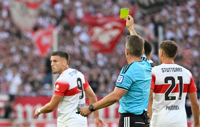 After a tackle, Foul by Ermedin Demirovic (VfB Stuttgart 09) against Waldemar Anton (Borussia Dortmund BVB 03); referee Tobias Stieler shows Ermedin Demirovic (VfB Stuttgart 09) a yellow card; VfB Stuttgart vs. Borussia Dortmund BVB 19 09 2026 DFL regulations prohibit any use of photographs as image sequences and or quasi-video. VfB Stuttgart vs. Borussia Dortmund BVB