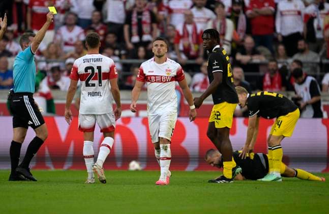 September 19, 2026, Soccer, Bundesliga 1, 2026–2027, Matchday 4, VfB Stuttgart vs. Borussia Dortmund, at the MHP Arena in Stuttgart, Ermedin Demirovic of Stuttgart receives a yellow card from referee Tobias Stieler. Germany