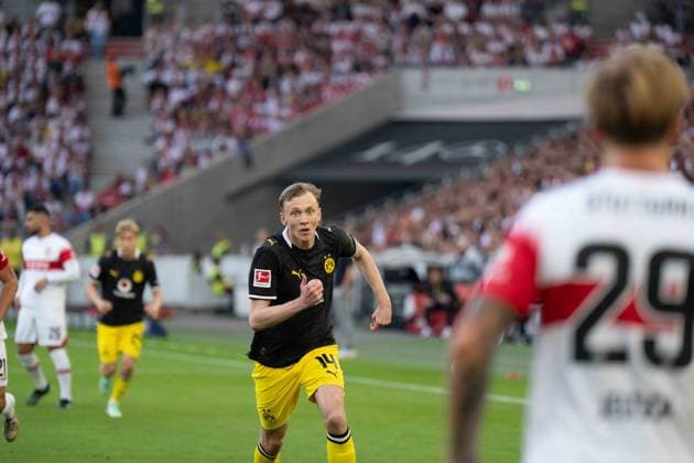 September 19, 2026: Soccer – VfB Stuttgart vs. Borussia Dortmund, Matchday 4 of the Bundesliga 1 at the MHP Arena. Maximilian Beier of Borussia Dortmund (No. 14) runs toward Finn Jeltsch of VfB Stuttgart (No. 29) with a determined look on his face, IMPORTANT NOTICE: In accordance with DFL and DFB regulations, it is prohibited to use or allow the use of photographs taken in the stadium and or during the game in the form of sequential images and or video-like photo series. Copyright: xJamesxZabelx