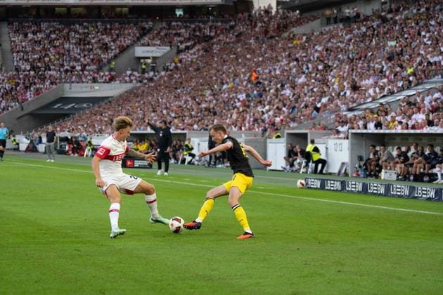 September 19, 2026, Soccer: VfB Stuttgart vs. Borussia Dortmund, Matchday 4 of the 1. Bundesliga at the MHP Arena; Maximilian Beier (Borussia Dortmund), 14 vs. Finn Jeltsch (VfB Stuttgart), 29 in attendance, IMPORTANT NOTICE: In accordance with DFL and DFB regulations, it is prohibited to use or allow the use of photographs taken in the stadium and or during the game in the form of sequential images and or video-like photo series. Copyright: xJamesxZabelx