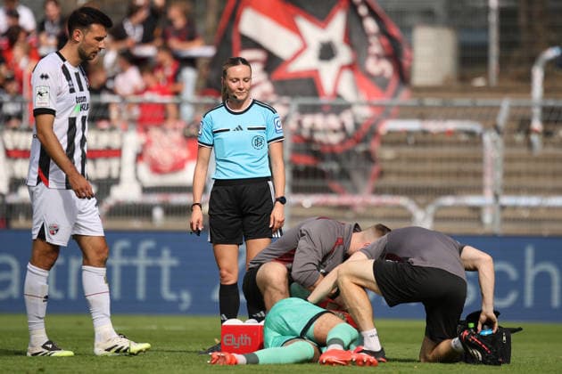 September 19, 2026, xsefx, Soccer, FC Viktoria Köln vs. FC Ingolstadt 04, 3rd Division, Sportpark Höhenberg, Matchday 7, 2026–2027 Season. Referee Fabienne Michel observes the treatment of goalkeeper David Klein of FC Ingolstadt 04 (47 ). DFB regulations prohibit any use of photographs as image sequences and or quasi-video. North Rhine-Westphalia, Germany