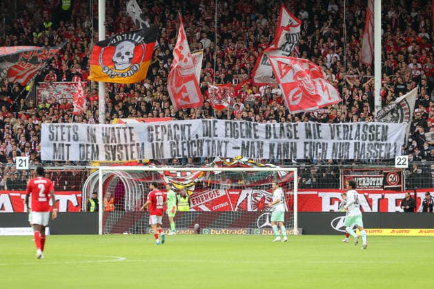 September 20, 2026, xtgx, Soccer 2. Bundesliga, FC Energie Cottbus vs. FC St. Pauli, from left: stock photo, stock image, fans, spectators, audience, Grandstand, banner, slogan: Always wrapped in cotton wool, never leaving your own bubble. In step with the system—you’re just impossible to like. DFL DFB REGULATIONS PROHIBIT ANY USE OF PHOTOGRAPHS as IMAGE SEQUENCES and or QUASI-VIDEO Cottbus
