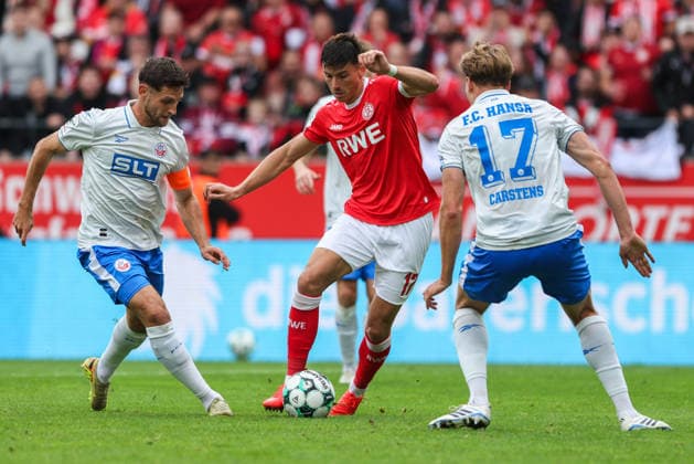 Soccer, 3rd Division, Matchday 7: Rot Weiss Essen vs. Hansa Rostock on September 20, 2026, at the Hafenstraße Stadium in Essen. Marco Schuster (Rostock), left; Semir Telalovic (Essen), center; Florian Carstens (Rostock), right. DFB regulations prohibit any use of photographs as image sequences and or quasi-video. xJRx