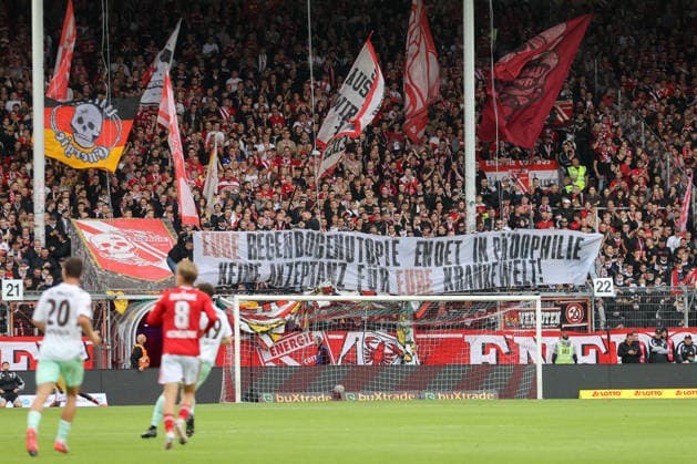 September 20, 2026, xtgx, Soccer, 2. Bundesliga, FC Energie Cottbus vs. FC St. Pauli, from left: stock photo, stock image, fans, spectators, audience, Grandstand banner: Your rainbow utopia ends in pedophilia. No acceptance for your sick world. DFL DFB regulations prohibit any use of photographs as image sequences and or quasi-video. Cottbus