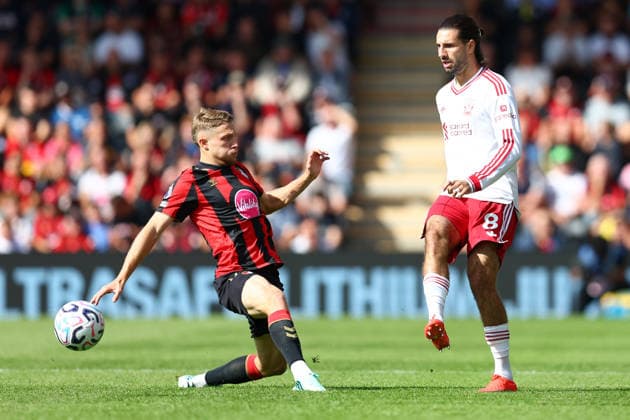 Bournemouth, England, 20th September 2026. Dominik Szoboszlai of Liverpool plays the ball past Adrien Truffert of AFC Bournemouth during the AFC Bournemouth vs Liverpool Premier League match at the Vitality Stadium, Bournemouth. Picture credit should read: Paul Terry Sportimage EDITORIAL USE ONLY. No use with unauthorised audio, video, data, fixture lists, club league logos or live services. Online in-match use limited to 120 images, no video emulation. No use in betting, games or single club league player publications. SPI_011_PT_Bournemouth_Liverpool SPI-5013-0011