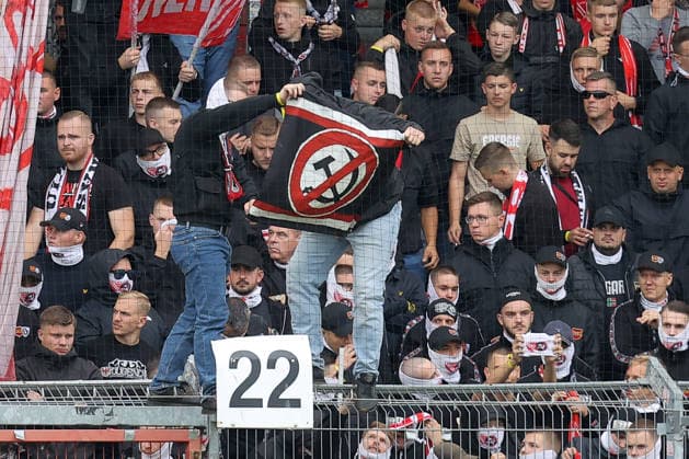 September 20, 2026, xtgx, Soccer 2. Bundesliga, FC Energie Cottbus vs. FC St. Pauli, from left: Cottbus fans display a crossed-out hammer and sickle emblem; communism, socialism; DFL and DFB regulations prohibit any use of photographs as image sequences and or quasi-video; Cottbus