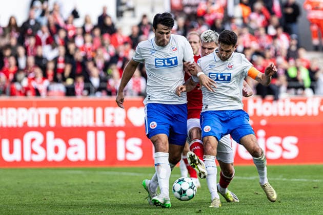 3rd Division, Matchday 7: Rot-Weiss Essen vs. Hansa Rostock, September 20, 2026; Ahmet Gürleyen (Hansa Rostock), 15; Marek Janssen (Rot-Weiss Essen), 20; Marco Schuster (Hansa Rostock), 5; 3rd Division, Matchday 7: Rot-Weiss Essen vs. Hansa Rostock at Stadion an der Hafenstraße, Essen, September 20, 2026. DFL regulations prohibit any use of photographs as image sequences and or quasi-video. Copyright: xBEAUTIFULxSPORTS Buriakovx