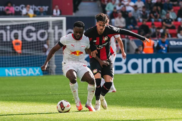 September 20, 2026, xjmrgnx, Soccer, Bundesliga 1, Bayer 04 Leverkusen vs. RB Leipzig: A tackle between Ridle Baku (17), Leipzig, and Afonso Moreira (9), Leverkusen. DFL and DFB regulations prohibit any use of photographs as image sequences and or quasi-video. Leverkusen