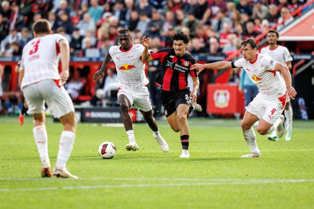 LEVERKUSEN, GERMANY - SEPTEMBER 20, 2026: Ibrahim Maza (Bayer 04 Leverkusen, 30) tackled by Ezechiel Banzuzi (RB Leipzig, 6) and Willi Orban (RB Leipzig, 4) during the German Bundesliga match on gameday 4 between Bayer 04 Leverkusen vs. RB Leipzig at BayArena on September 20, 2026 in Leverkusen, Germany. DFL REGULATIONS PROHIBIT ANY USE OF PHOTOGRAPHS AS IMAGE SEQUENCES AND OR QUASI-VIDEO. Northrhine-Westphalia Germany Copyright: xAxelxKohringx