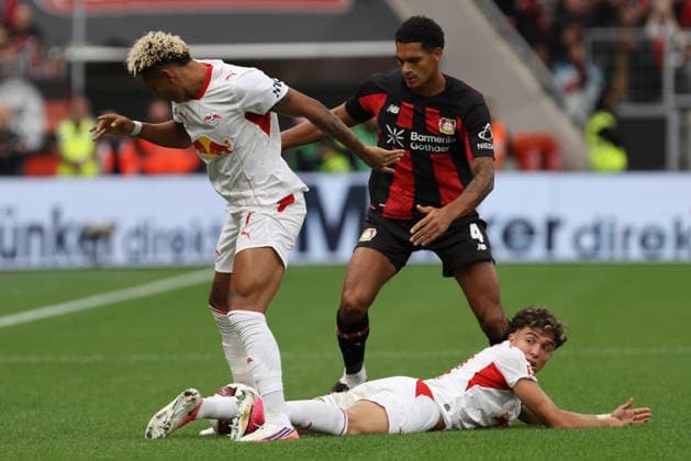 Antonio Nusa (RB Leipzig), Jarell Quansah (Bayer 04 Leverkusen), and Neil El Aynaoui (RB Leipzig) in a tackle during the Bundesliga 1 match between Bayer 04 Leverkusen and RB Leipzig, BayArena on September 20, 2026, in Leverkusen, Germany. Photo by Oliver Kaelke, DeFodi Images. Antonio Nusa (RB Leipzig), Jarell Quansah (Bayer 04 Leverkusen) and Neil El Aynaoui (RB Leipzig) battle for the ball during the Bundesliga match between Bayer 04 Leverkusen and RB Leipzig at BayArena on September 20, 2026 in Leverkusen, Germany. Photo by Oliver Kaelke, DeFodi Images. DFB and DFL regulations prohibit any use of photographs as image sequences and or quasi-video. Photo by Oliver Kaelke, DeFodi Images