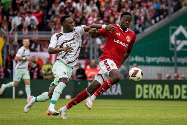 Cottbus, Germany, September 20, 2026, 2nd Bundesliga 2026–2027, Matchday 6: FC Energie Cottbus vs. FC St. Pauli. Pictured (from left) in a tackle: Abdoulie Ceesay (St. Pauli) and King Manu (Energie Cottbus). DFL and DFB regulations prohibit any use of photographs as image sequences and or quasi video. LEAG Energie Stadium Brandenburg Copyright: xFotostandx xWeilandx
