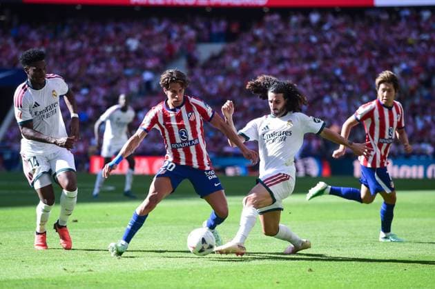 (260921) -- MADRID, Sept. 21, 2026 -- Atletico de Madrid s Giuliano Simeone (front L) vies with Real Madrid s Marc Cucurella (front R) during a La Liga football match between Atletico de Madrid and Real Madrid at Riyadh Air Metropolitano stadium in Madrid, Spain, on Sept. 20, 2026. (Photo by Xinhua) (SP)SPAIN-MADRID-FOOTBALL-LALIGA-ATLETICO MADRID VS REAL MADRID GustavoxValiente 