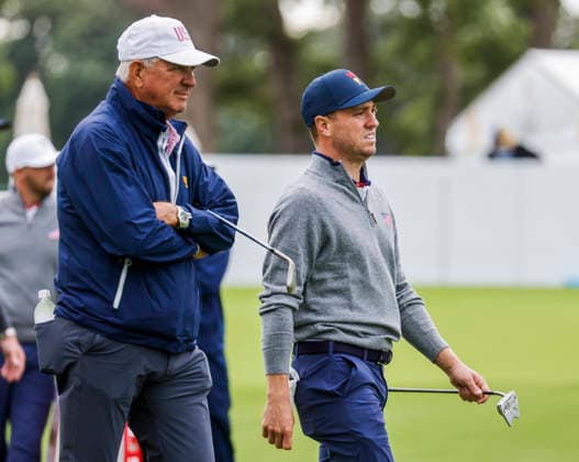 Justin Thomas of the US (R) walks with his father Mike Thomas (L) on the fourteenth hole during practice for the Presidents Cup golf tournament at Medinah Country Club in Medinah, Illinois on Monday, September 21, 2026. Competition between the USA and the International team begins on Thursday, September 24 with Four-Ball play.  MED20260922807 TANNENxMAURY