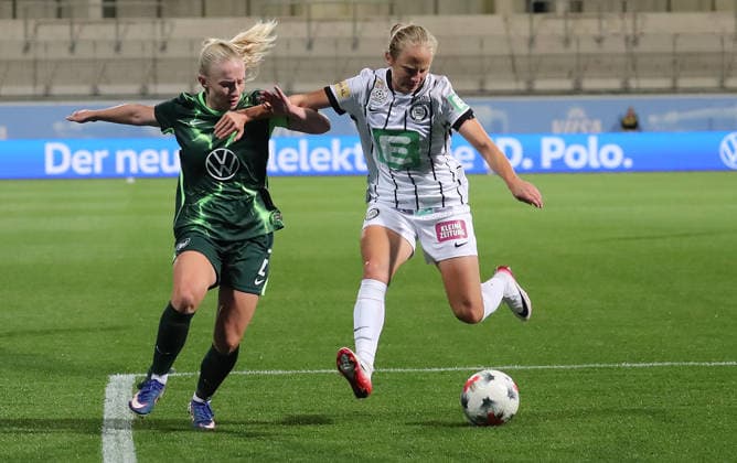 Thea Bjelde of VfL Wolfsburg faces off against Sara Pavlovic of Sturm Graz; Soccer, Women s, 2026–2027 Season, UEFA, Women s Europa Cup Qualifying, Round 2, AOK Stadium Wolfsburg, VfL Wolfsburg vs. Sturm Graz