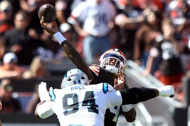 Cleveland Browns Deshaun Watson (4) throws a pass as he is hit by Carolina Panthers Aaron Hall (94) in the second quarter at Huntington Bank Field in Cleveland, Ohio on Sunday September 27, 2026.  CLE20260927110 AARONxJOSEFCZYK