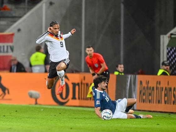 Kevin Schade of Germany and Thanasis Androutsos of Greece battle for the ball during the UEFA Nations League 2026–27 group stage match between Germany and Greece at WWK Arena on September 27, 2026, in Augsburg, Germany. Photo by Harry Langer, DeFodi Images