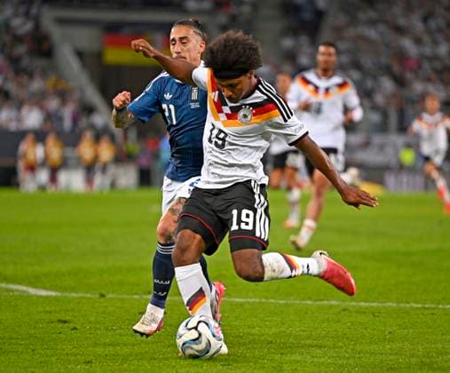 September 27, 2026, Soccer: UEFA Nations League 2026–2027, Matchday 2, Germany vs. Greece, at the WWK Arena in Augsburg; from left: Kostas Tsimikas (Greece) vs. Karim Adeyemi (Germany)