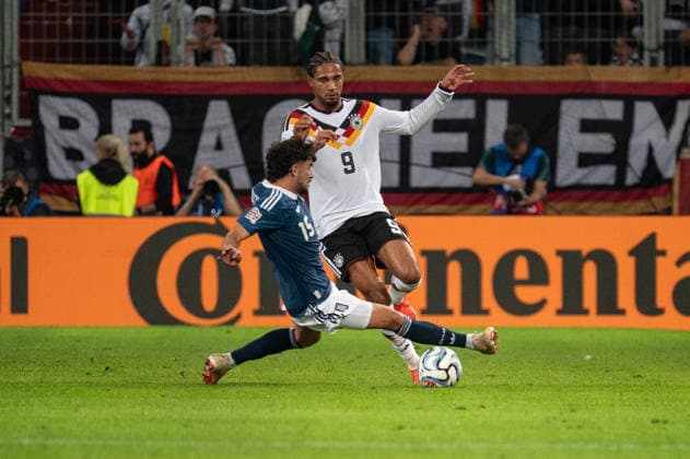 GER, Bavaria, Augsburg, soccer, Germany vs. Greece, at the WWK Arena, Augsburg, UEFA Nations League, Matchday 2, group stage, September 27, 2026, from left: Thanasis Androutsos (Greece), 15, Kevin Schade (Germany), 9, in a tackle; Graetsche. DFL and DFB regulations prohibit any use of photographs as image sequences and or quasi-video, Copyright: HMB-Media MichaelxNibel