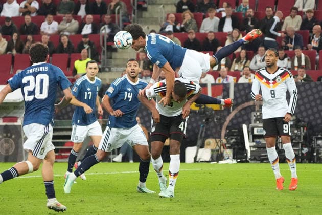 Ntinos Mavropanos of Greece defends with total commitment against Jonathan Tah of Germany, Augsburg, September 27, 2026; Germany vs. Greece, UEFA Nations League, WWK Arena, Matchday 2