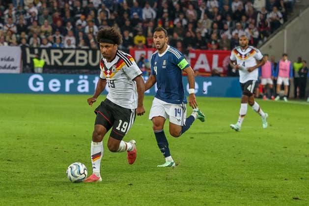 Karim Adeyemi 19 (Germany) in action against Vangelis Pavlidis 14 (Greece), Germany vs. Greece, Soccer, DFL, DFB, UEFA Nations League, 2026–2027 season, group stage, Group B, Matchday 2 of 6, September 27, 2026, Augsburg, Bavaria, Germany Copyright: xkolbert-press MartinxAgüerax