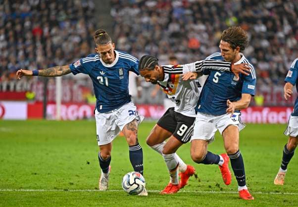 September 27, 2026, UEFA Nations League 2026–2027, Matchday 2, Germany vs. Greece, at the WWK Arena in Augsburg; from left: Kostas Tsimikas (Greece), Kevin Schade (Germany), and Panagiotis Retsos (Greece)